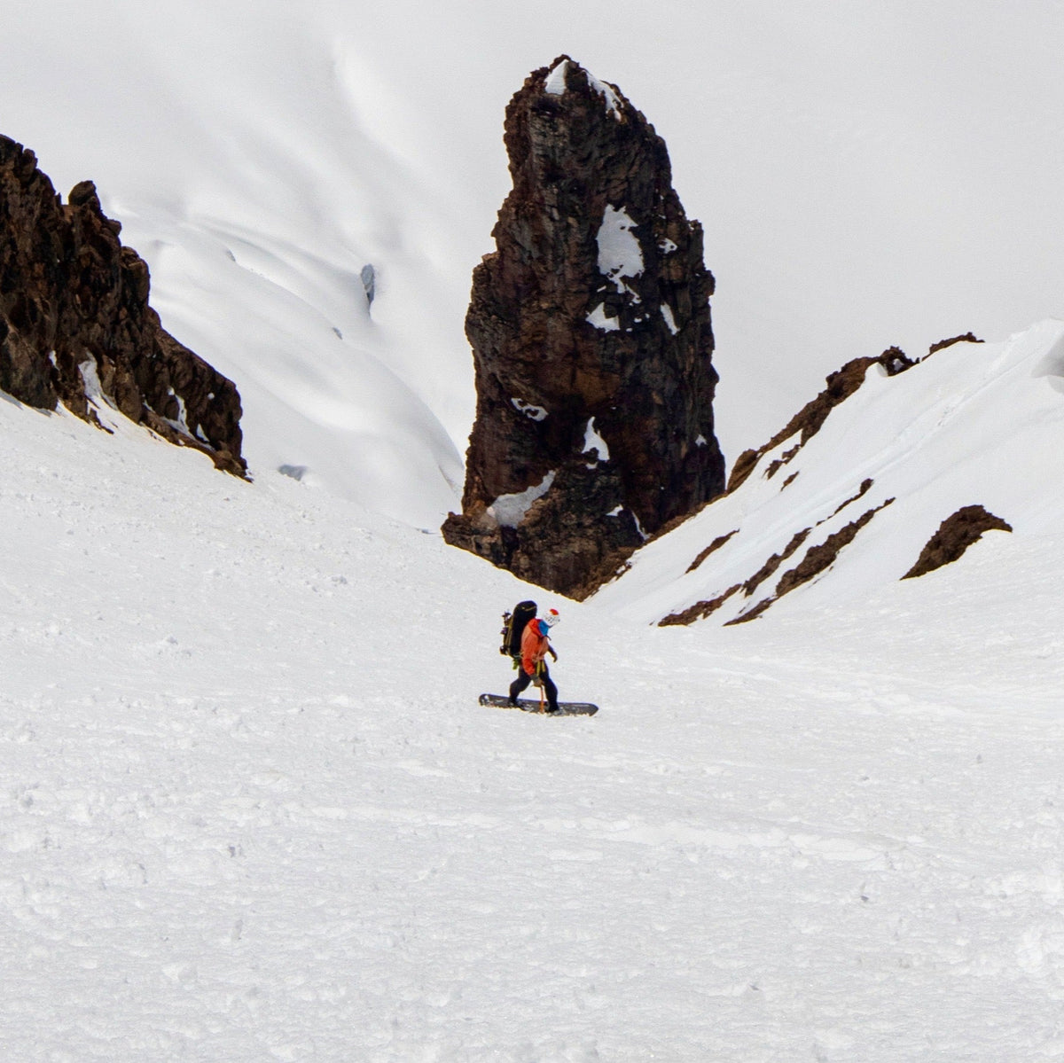 Splitboard Guide Jere Burrell descends the South Couloir on Colfax Peak on Mount Baker during a guided descent. 