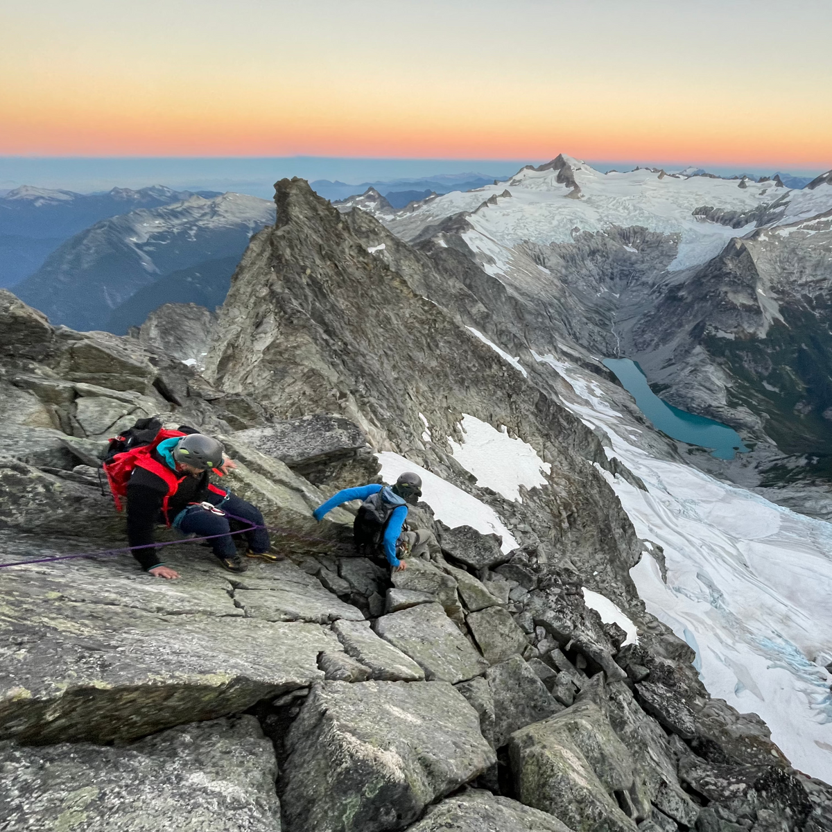 climbers on the west ridge of forbidden peak in north cascades national park during sunrise